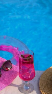 pink cocktail with flamingos on the background of the pool. Selective focus.