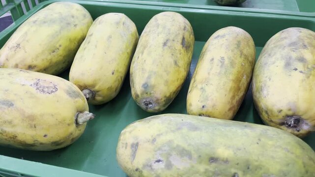 Fresh ripe organic papayas display at local market