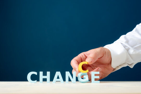 Change management and business transformation concept with hand changing a letter