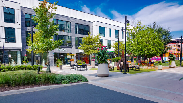 Parked cars border landscaped sidewalks through One Loudoun in Ashburn, Virginia.