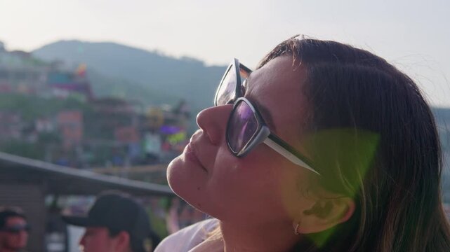 Woman enjoying the sunshine in comuna 13 in medellin