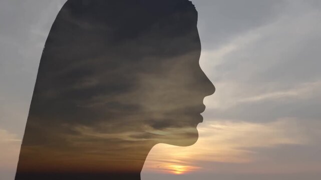 Woman profile silhouette with sunset clouds in double portrait