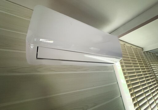 Modern air conditioner unit mounted on wall in contemporary home living room interior for climate control 