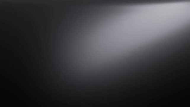 Soft light sweeps across dark black background as a gray gradient shifts from left to right