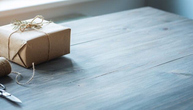 Kraft Paper Gift Wrapping on Wooden Table with Copy Space