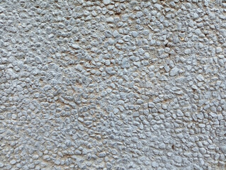 Coarse gray pebble dash exterior wall texture closeup with building material surface texture finish material exterior © difre