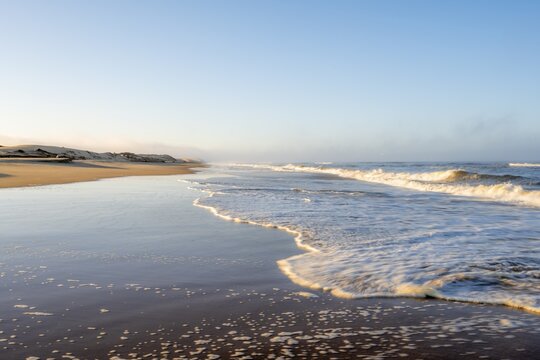 Waves burn on sandy beach, Atlantic coast in the Namib Desert, Sandwich Harbour, Namib Naukluft Park, Namib Desert, Namibia