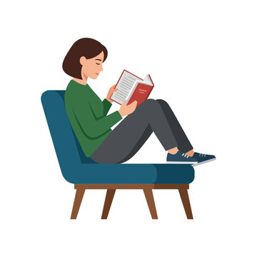 Young woman sitting in a comfortable armchair reading a book