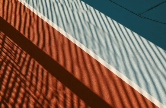 Diagonal stripes of red, white, and blue create abstract patterns with shadow play