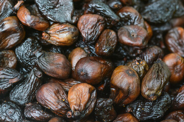 Fototapeta premium Full frame background texture of dried black figs (sun-dried black mission figs).