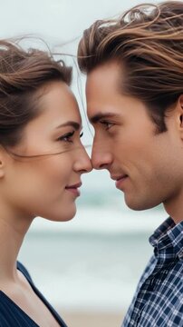 Close up portrait of a young Caucasian couple in love looking deeply into each other eyes on the beach, romantic concept for relationship and dating stock photos