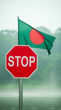 Stop sign in front of the flag of Bangladesh representing national laws and traffic regulations in South Asia