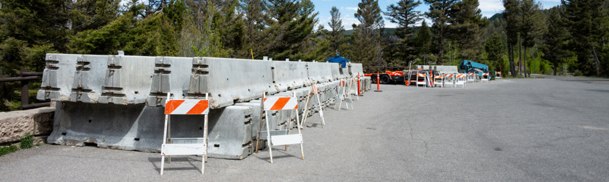 Summer construction season work zone, concrete Jersey Barriers and traffic barriers in road pullout parking lot staging area, Yellowstone National Park
