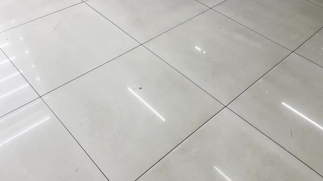 Wide angle shot of glossy marble floor with linear light reflection