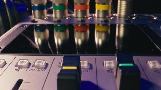 Music studio close up, Close up hands shot of sound engineer using mixing console, remote control for adjusting sound, audio mixer. Musician creates music, makes remix for DJ set. Sound
