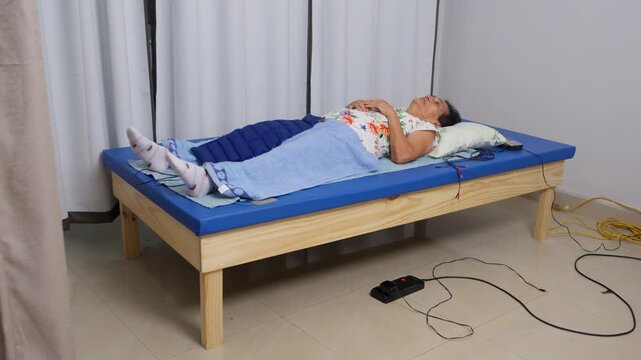 Senior woman receiving physical therapy rehabilitation treatment