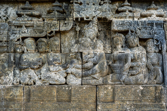 Borobudur stone relief carving depicting buddhist figures