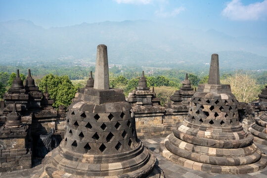 Borobudur buddhist stupas on java island with mountains