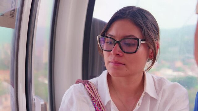 Woman riding a cable car in medellin, colombia
