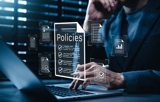 Policy documentation and compliance concept. Businessman reviews digital document labeled "Policies" with icons, checklists, certifications, financial detail. policy management, regulatory compliance