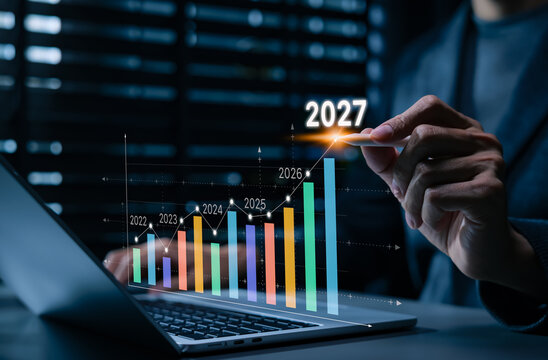 2027 business growth forecast and strategic planning concept. Businessman using laptop and chart, financial performance, market trends, revenue growth, analytics, investment outlook, future success