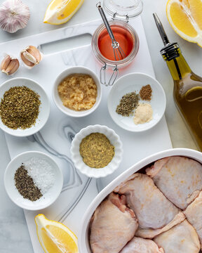 A collection of fresh ingredients used for making a chicken marinade.