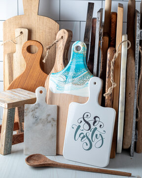 Several assorted cutting boards all leaning against each other. 