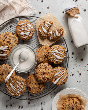 A cooling rack topped with homemade quinoa cookies served with milk.