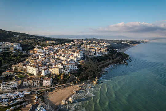 Aerial View of Sperlonga Village with White Buildings and Rocky Coastline at Golden Hour