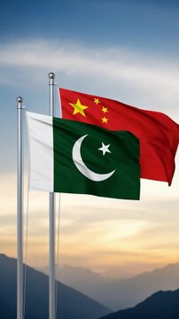 Pakistan and China flags waving together on flagpole against mountain landscape representing diplomatic alliance and bilateral cooperation