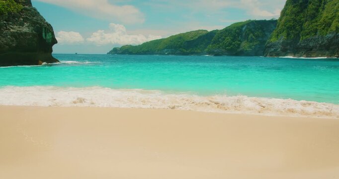 Sunny tropical coast ideal for vacation and leisure at Kelingking Beach Bali Nusa Penida