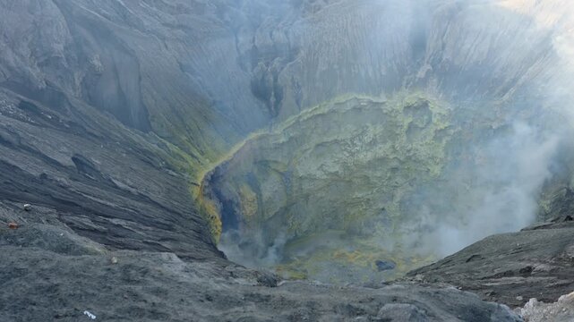 Smoking bromo volcano crater emitting sulfuric gas