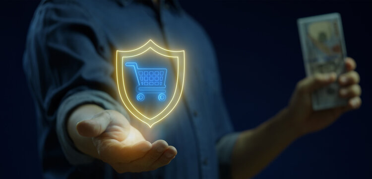 Businessman holding dollar banknotes while open hand supporting glowing shopping cart security shield. Secure online retail payment transaction, e-commerce buyer fraud defense, and money concept.
