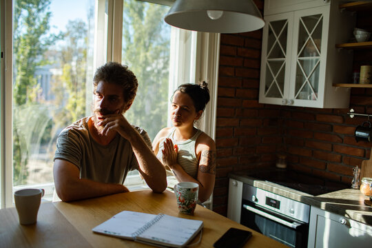 Couple having difficult conversation at kitchen table