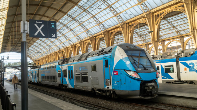 Nice, France &ndash; December 25, 2025: A blue SNCF TER train sits under the grand arched roof of Nice-Ville station.