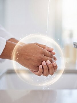 Person washing hands under running water with a glowing golden protective barrier effect in bathroom with sphere effect surrounding stream running person washes sanitization