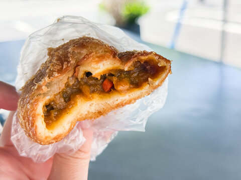 日本のカレーパンの断面。スパイシーなカレールーが中に入ってる揚げパン。食べかけ。
