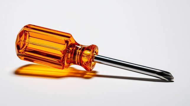 Orange stubby phillips screwdriver resting on a white surface in a sharp macro studio shot for hardware marketing and home repair branding