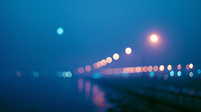 Blurred lights on a misty night over water with reflections.