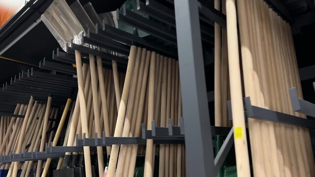Rows of New Shovels with Wooden Handles on Store Rack | Garden Tools Display in Hardware Shop | Wide Assortment of Spades Hanging in Retail Warehouse