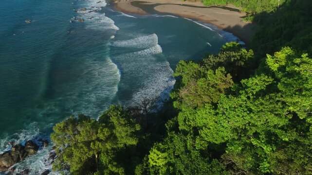 remote beach in costa rica during susnet shot on a drone