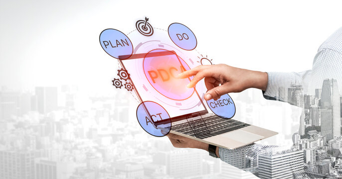 Business Strategy Concept with Plan Do Check Act Framework Displayed on Laptop Screen in Modern City Environment. Bitwise.