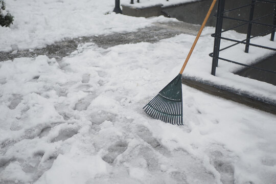 Snow removal with a rake on a winter day