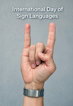 Closeup hand gesture showing sign language symbol for peace or victory on neutral background