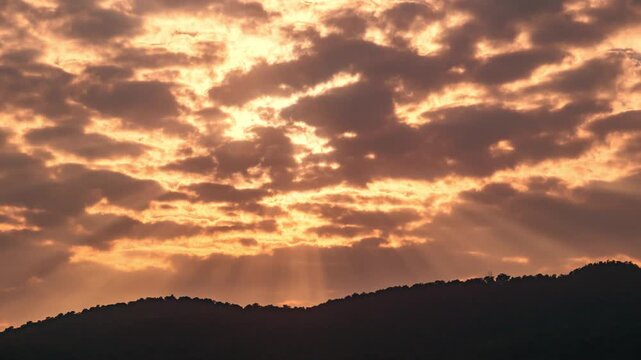 Wide angle time-lapse of scenic mountain range at sunset, dramatic cloud formations and natural beauty.