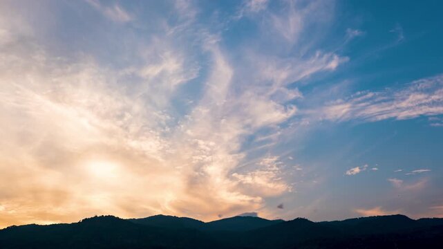 Time-lapse of evening sky changing from orange to deep blue at twilight.