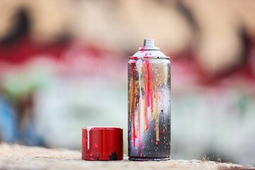 Street art and urban culture, spray paint can with colorful drips on a concrete surface for creative expression and graffiti mural design projects © Pixel-Shot