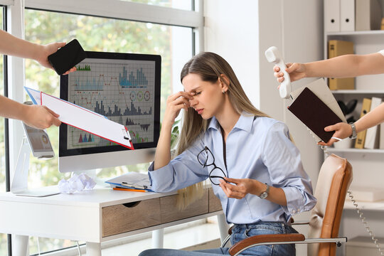 Burnout and workplace stress, exhausted employee overwhelmed by multiple tasks and demands in a busy office environment with financial data analysis