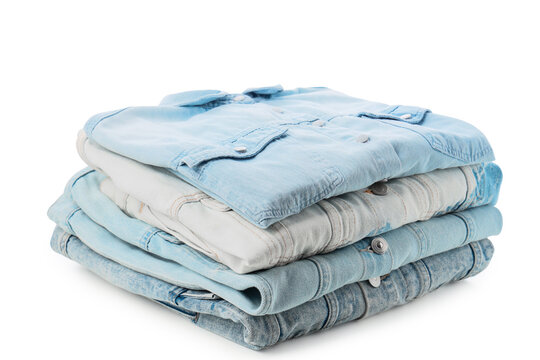 Sustainable fashion and clothing consumption, stack of folded denim jackets for retail or wardrobe organization isolated on a white background