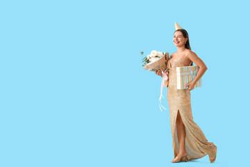 Naklejka premium Birthday celebration and party lifestyle, happy woman in gold sequin dress holding gift box and flowers on blue background